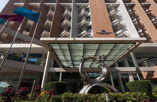 Un edificio con una statua davanti di Long Beach Hotel a Cox's Bazar