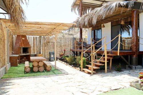 a patio with a house with a staircase and a table at La Vidita 891 - Piscinas, Lobitos in Lobitos