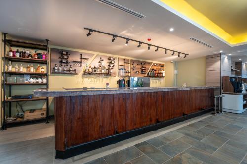a kitchen with a bar in a restaurant at The Skye Phnom Penh Hotel & Apartments in Phnom Penh