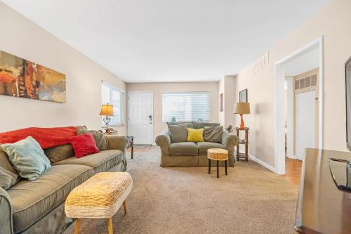 a living room with a couch and a chair at Longer Stays for Travelers- Apt Blocks from Hospital, Downtown in Visalia