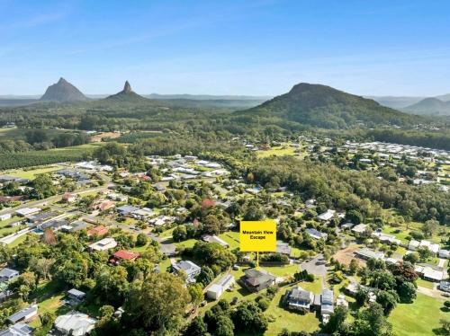an aerial view of a suburb with mountains in the background at Mountain Views, Spa Bath, Pet Friendly, Near Zoo! in Glass House Mountains