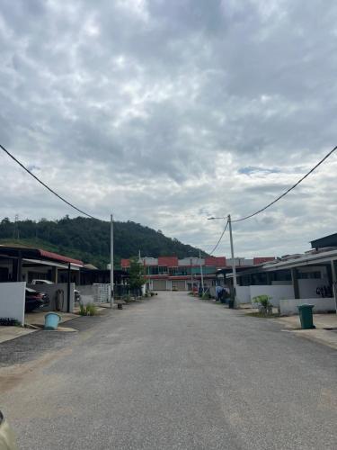 an empty parking lot in a town with buildings at Inap Kasih Homestay GM in Gua Musang