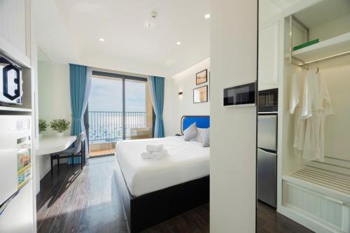 a hotel room with a bed and a balcony at Luna Sol Villas - Dedicated Care Until Check Out in Phu Quoc