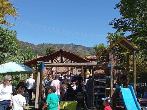 a crowd of people standing around a playground at Hostal Santa Isabel in Iza