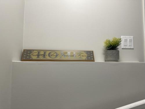 a shelf with a plant on top of a refrigerator at Luxury-Home Away from Home with Private Entrance in Winnipeg