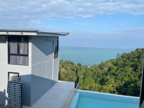 a view from the balcony of a house with a swimming pool at Scenery Sunrise in Chaweng Noi Beach
