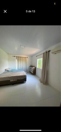a large bedroom with a bed and a window at Dila Beach House - Praia dos Algodões - Maraú in Praia dos Algodões