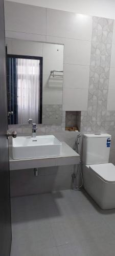 a bathroom with a sink and a toilet at Sea Light Mirissa in Mirissa