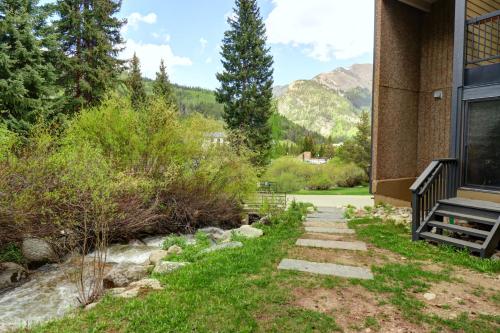 a walkway outside of a building with mountains in the background at CM417H Copper Mtn Inn in Copper Mountain