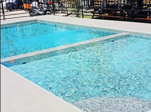 a swimming pool with blue water in a building at Sunbeams Studio Unit in Lapu Lapu City