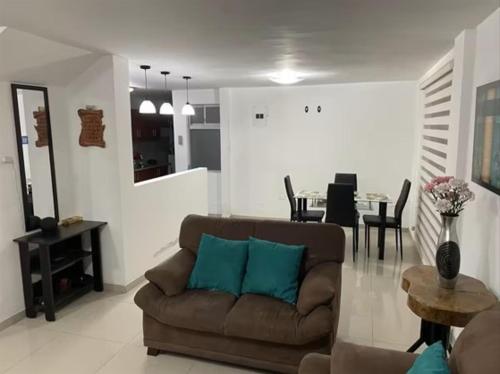 a living room with a couch and a dining room at Aeropuerto Internacional Quito Habitacion 1 in Quito