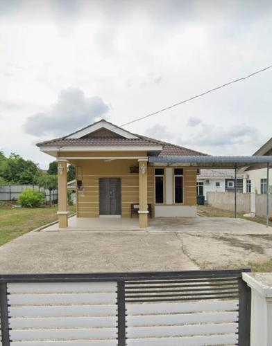 a house with a gate in front of it at Aja Retreat Bungalow OnlyMuslim in Jitra