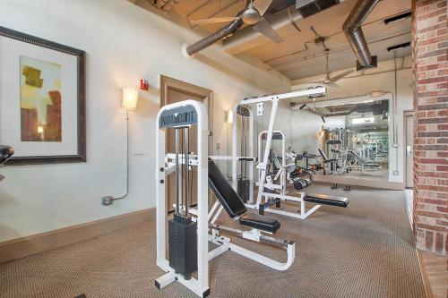 a gym with several tread machines in a room at Cowtown 1 bedroom Downtown FTW in Fort Worth