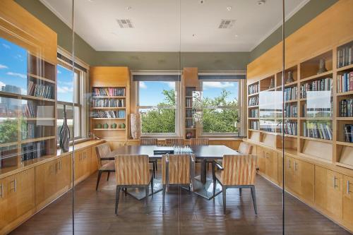 a dining room with a table and chairs and bookshelves at Cowtown 1 bedroom Downtown FTW in Fort Worth