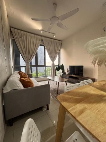 a living room with a couch and a tv at Wallaway2stay Gravit8 Klang 2Room in Klang