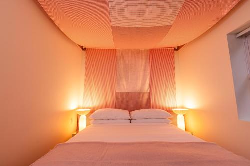 a bedroom with a large bed with two lamps at Ode in Toronto