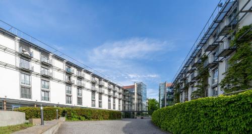 an empty street in front of a large building at PLAZA Residence Stuttgart-Ditzingen in Ditzingen