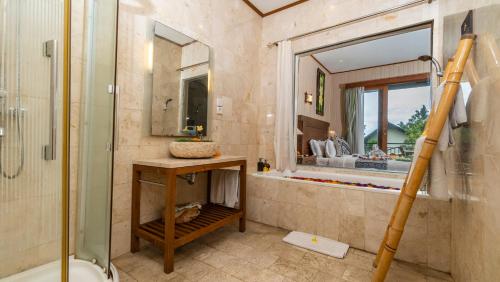 a bathroom with a shower and a sink and a mirror at Gita Maha Ubud Hotel by Mahaputra-CHSE Certified in Ubud