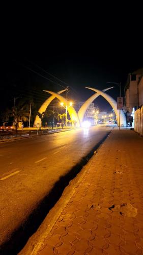 an empty street at night with a bridge in the background at Mombasa cosy 2bdrm in Mombasa