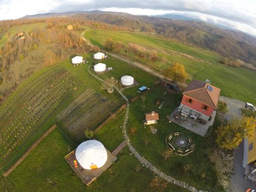 an aerial view of a farm with domes and a house at Società Agricola Cacigolara in Borgo Val di Taro