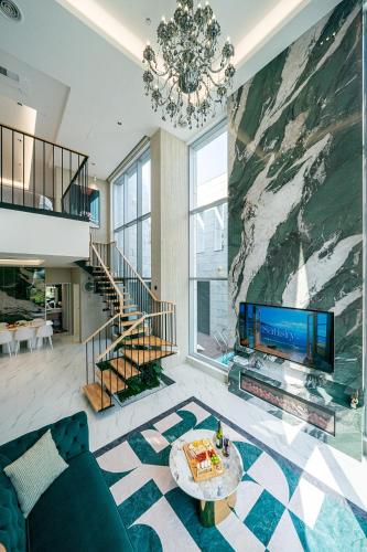 a living room with a fireplace and a large tv at Eudaimonia Poolvilla Jeju 에다모니아 함덕풀빌라 in Jeju