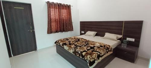 a bedroom with a large bed with a wooden headboard at Brij Dham in Vrindāvan
