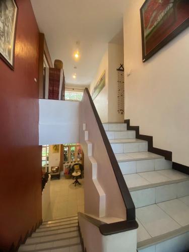 a staircase in a house with a stair case at The Journey House Lifestyle Boutique Hotel in Kanchanaburi