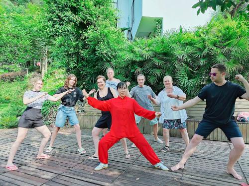 a group of people dancing on a wooden deck at Yangshuo Mountain Vista Courtyard in Yangshuo
