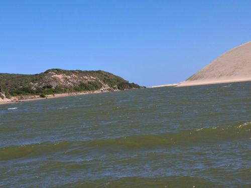 a body of water with a beach in the background at Addo River Den in Gqeberha