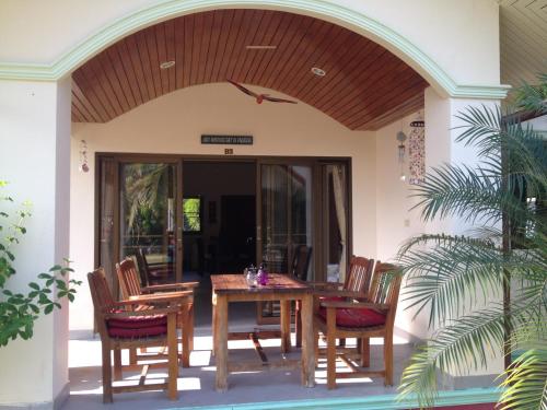 a dining room with a table and chairs on a patio at Paradis Villa B3 in Ko Kho Khao