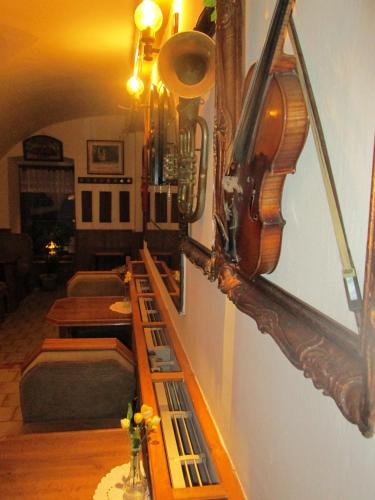 a living room with a violin on the wall at Penzion U Holubů Nový Jičín in Nový Jičín