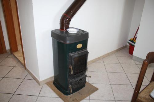 a wood stove sitting on a floor in a room at Al Seminario in Tivoli