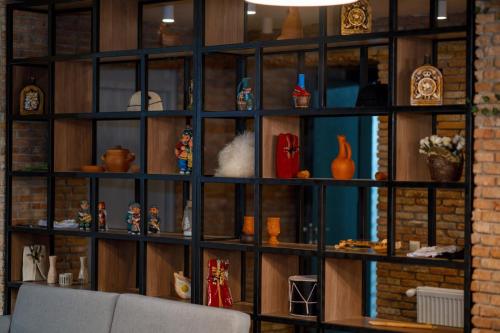 a room with a wall of shelves filled with items at Gоderdzi Twins Hotel in Goderdzi