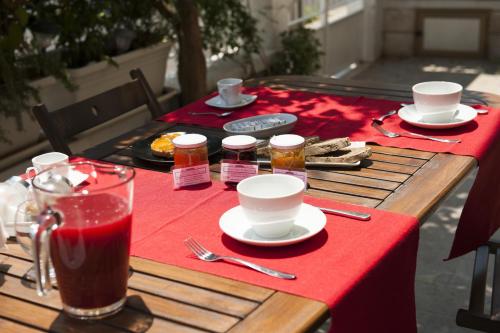 a table with a red table cloth and food on it at Briciole di Gusto in Lecce