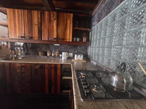 a kitchen with a stove and a counter top at Reefteach Lodge in Sodwana Bay