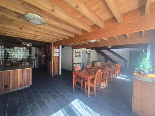 a dining room with a wooden table and chairs at Reefteach Lodge in Sodwana Bay