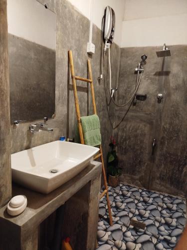 a bathroom with a sink and a shower at Lekham Walauwa in Matale
