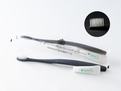 a toothbrush and a toothbrush wrapper next to a toothbrush at APA Hotel Kumamoto Sakuramachi Bus Terminal Minami in Kumamoto