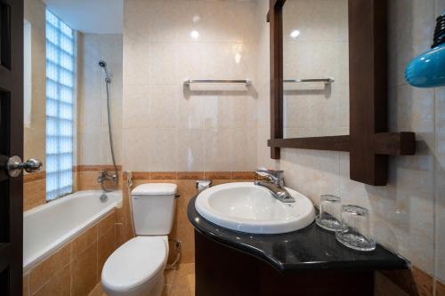 a bathroom with a sink and a toilet and a bath tub at Shine Hue Hotel 2 in Hue
