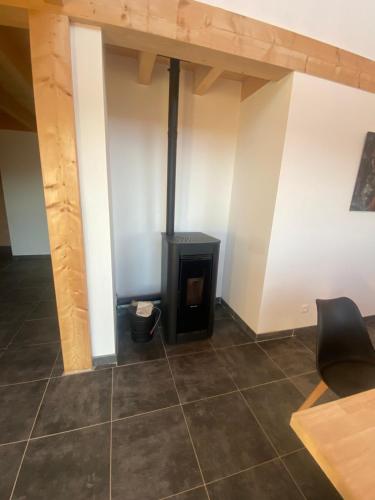a room with a stove in the middle of a room at Chalet des loulous , 3 chambres, 8 couchages in Font Romeu Odeillo Via
