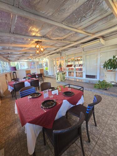 a dining room with a table and chairs in a restaurant at Loei Palace Hotel in Loei