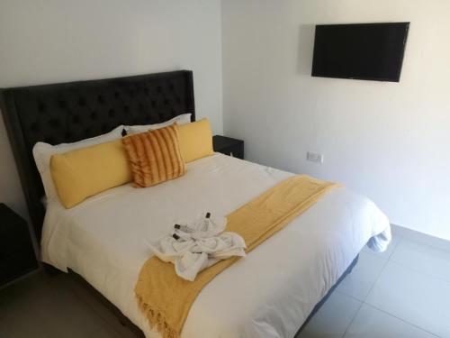 a bedroom with a bed with towels on it at Accomodation 5050 Jwaneng in Jwaneng