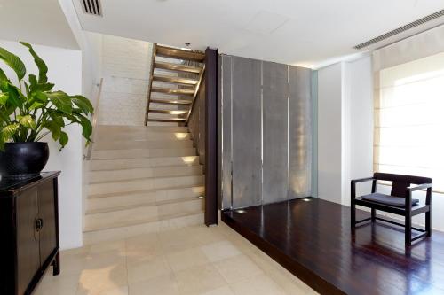 a hallway with a chair and stairs in a house at Establishment Hotel in Sydney