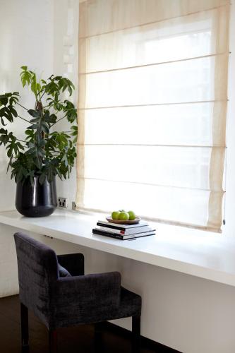 a plant sitting on a window sill next to a chair at Establishment Hotel in Sydney