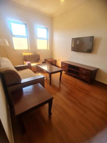 a living room with a couch and a flat screen tv at FBK Guest House in Addis Ababa