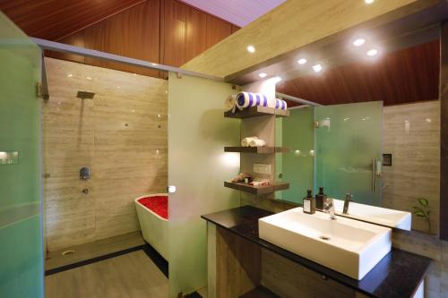 a bathroom with a sink and a shower at The Grand Retreat - Chikmagalur in Chikmagalūr