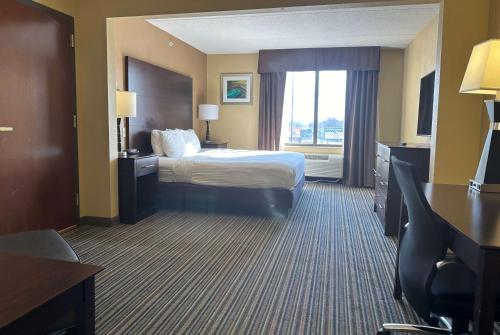 a hotel room with a bed and a window at Wingate by Wyndham Harrisburg Near Hershey in Harrisburg