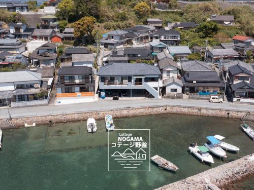 an aerial view of a marina with boats in the water at コテージ野釜 in Kami Amakusa