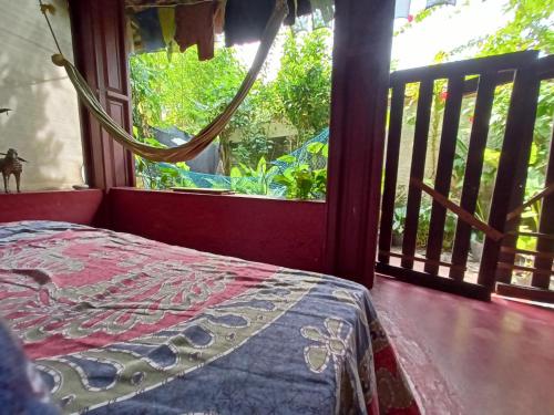 a bedroom with a bed and a large window at The Blues in Alleppey