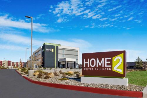 a home sign in front of a building at Home2 Suites By Hilton Colorado Springs Airport in Colorado Springs
